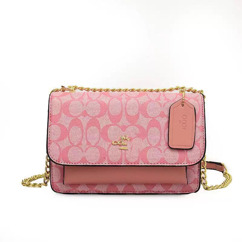 Pink signature print crossbody bag with gold chain strap, flap closure, and tag detail.